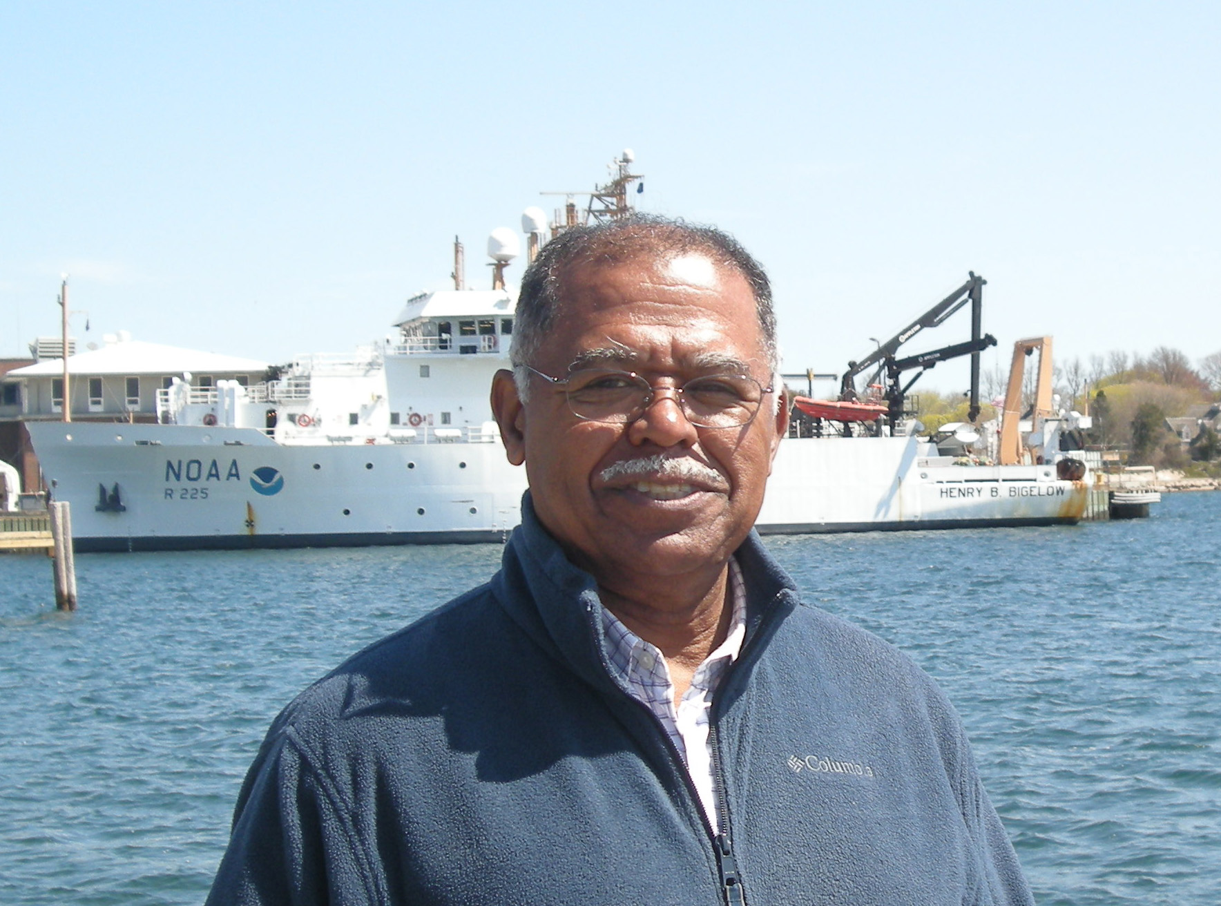 Ambrose Jearld Jr., with the NOAA Ship Henry B. Bigelow in the background. Photo credit: NOAA Fisheries/Shelley Dawicki, NEFSC