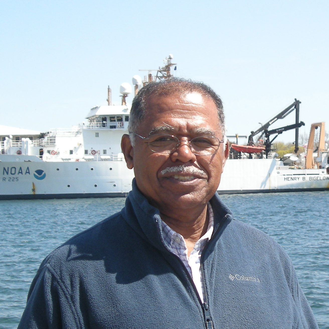 Ambrose Jearld Jr., with the NOAA Ship Henry B. Bigelow in the background. Photo credit: NOAA Fisheries/Shelley Dawicki, NEFSC